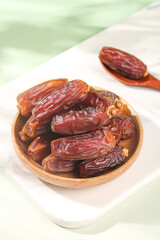 Fresh Medjool Dates in Wooden Bowl - Healthy Dried Fruit Snack on Marble Surface