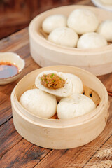 Handmade Steamed Pork Buns with Fresh Scallions in Traditional Bamboo Steamers
