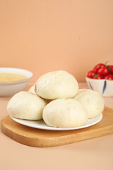 Big Fresh Handmade Steamed Buns with Meat Filling and Scallions on Wooden Board