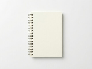 Minimalist vertical spiral notebook with a light cream-colored matte cover and silver metal binding isolated top-down view