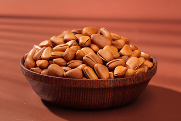 Pine Nuts in Wooden Bowl - Fresh Peeled Nuts on Wood Background