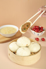 Handmade Chinese Pork and Scallion Steamed Buns with Fresh Stuffing in Bamboo Steamer