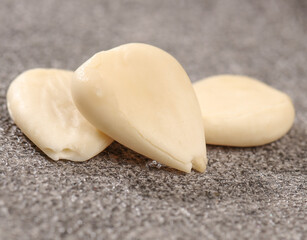 Fresh Peeled Garlic Cloves on Stone Surface - Natural Cooking Ingredient