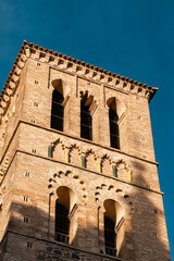 Fototapeta premium Warm Evening Light on a Mudejar Brick Tower Against Blue Sky
