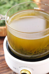 Fresh Pine Needle Tea Brewing in Glass Teapot - Herbal Infusion Health Drink