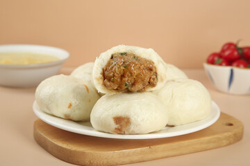 Handmade Pork and Scallion Steamed Buns - Traditional Asian Dumplings with Savory Filling on Wooden Board