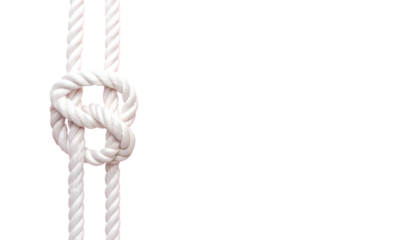 Close-up of a white rope tied in a complex knot against a stark black background (1)
