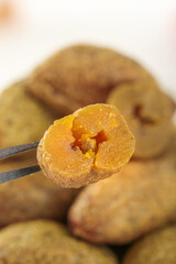 Dried Golden Fruit with Tweezers Close-up - Sweet Healthy Snack Ingredient