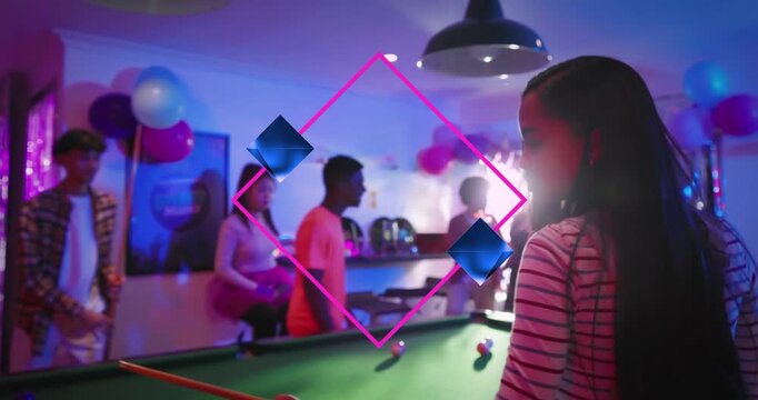 Striped-shirt teen picking up cue and making pool shot for party, pink diamond overlay guiding aim