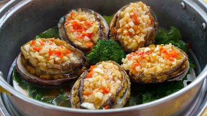 Steamed Abalone with Garlic Rice Stuffing Traditional Asian Seafood Dish in Steamer Pot