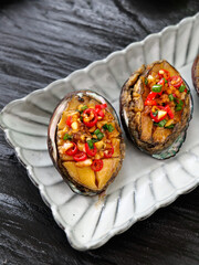 Big Steamed Abalone with Vegetables and Chili Peppers on White Plate
