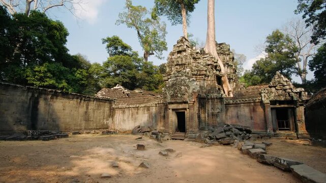 Stone ruins of the ancient ta prohm temple complex in cambodia slowly reclaimed by jungle trees and nature. A popular tourist destination. Cambodia, Siem Reap. Archeology concept.