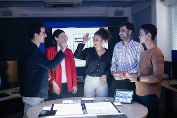 Diverse digital marketing and web development team celebrating success with a high five after a productive meeting. Successfully finished a complex UX UI project on creative AI application strategy