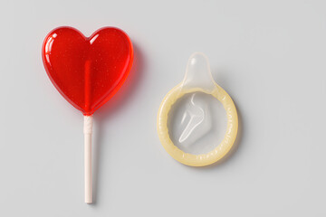 Safe Love Concept with Heart Lollipop and Condom