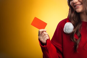 Young woman Christmas hat with phone and card, buying concept