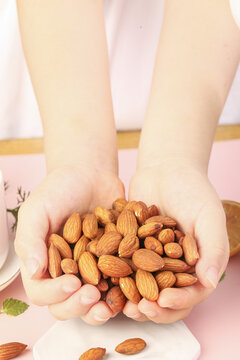 Hands Holding Roasted Almonds for Healthy Snacking