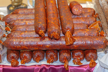 Stack of Hot Smoked Dry Pork Meat Cured Thick Sausages Delicatessen