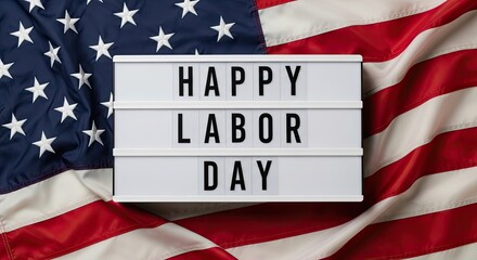 Celebrating Labor Day: A patriotic arrangement of an American flag with a sign that spells out Happy Labor Day.