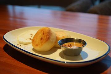 Cottage cheese Syrniki pancakes with on a plate with peanut butter and nuts