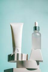 A soothing cream and a peptide serum are displayed on sculpted white pedestals with a flowing aqua backdrop. Perfect for skincare campaigns, editorial spreads, or luxury beauty product ads.