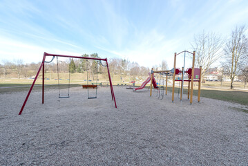 Playground with Swing Set and Slide on a Sunny Day in the Park