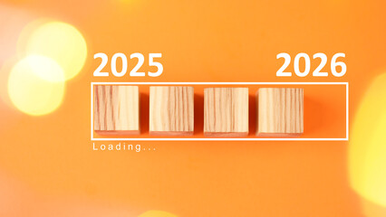 New Year 2026. Wooden cubes in loading bar on orange background, top view. Banner design