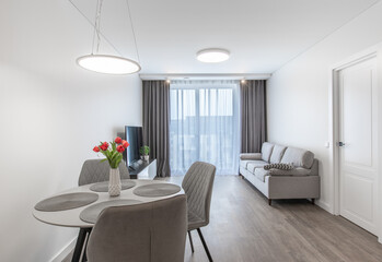 Modern Living Room With Dining Table and Large Windows for Natural Lighting