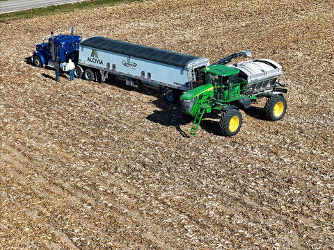 Poplar Grove, Illinois, November 3, 2025 - John deere 400R Dry Spinner Spreader being loaded with fertilizer
