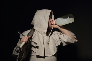 A formidable warrior monk with a sword drinks from a bottle filled with either an elixir or just moonshine.