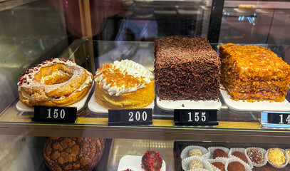 Assortment of sweet bakery and pastry displayed in showcase glass box. High quality photo.