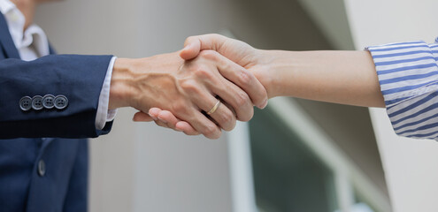 close up manager businessman handshake with investor woman after complete from special offer deal...