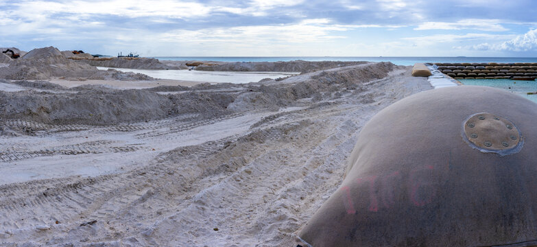 Reclaiming land in Tuvalu, an island nation in Pacific. Massive earth moving exercise is needed to counter rising seal levels and increasinly strong storms surges. - Powered by Adobe