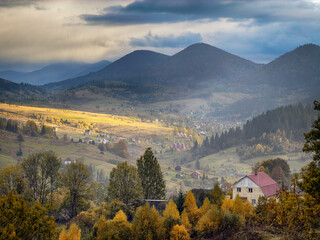 Sunny Autumn Carpathians with Puffy White Clouds