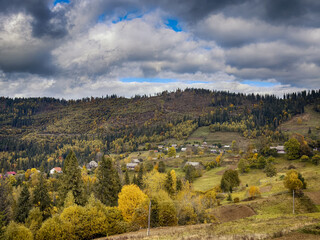 Sunny Autumn Carpathians with Puffy White Clouds