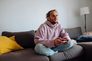 Comfortable guy immersed in gaming with cozy surroundings
