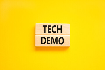Tech demo symbol. Concept word Tech demo on beautiful wooden blocks. Beautiful yellow paper background. Business tech demo concept. Copy space.