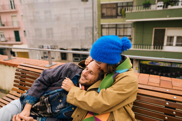 Intimate embrace with joyful partner on lively urban street