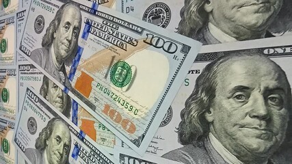 Smooth steady travel over detailed 100 dollar banknotes creating an exclusive visual space centered on investment success and the uninterrupted flow of money and circulating cash