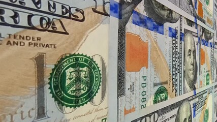 Cinematic sweep over textured 100 dollar banknotes forming an exclusive investment presentation that highlights the active nature of cash movement and the essence of money flow