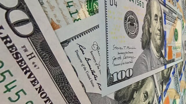 Fluid movement above textured 100 dollar banknotes generating an exclusive business visual designed to express investment stability and the ever present motion of money and cash