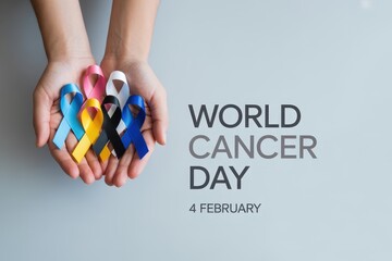 Hands holding colorful awareness ribbons for world cancer day