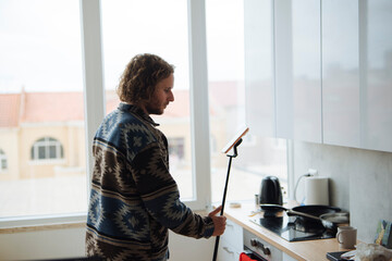 solo creator filming kitchen routine with selfie stick