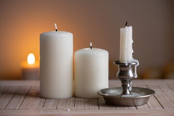 Candles on a wooden surface with soft light creating a warm atmosphere in the evening