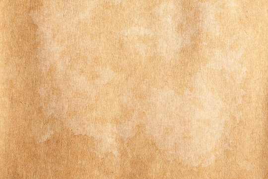 Old rustic brown distressed parchment paper texture with white stains