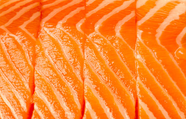 Fresh raw salmon fillets showing vibrant orange flesh texture and natural fish protein patterns for healthy eating
