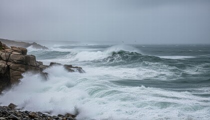 Stormy ocean waves crashing against rocky shore in overcast weather
