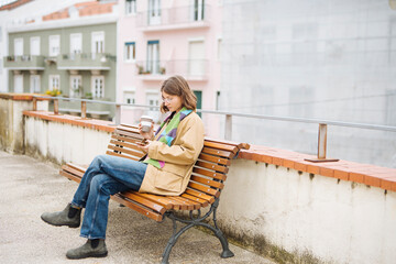 Female student immersed in reading amid tranquil courtyard surroundings