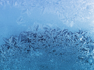 Beautiful ice patterns on winter window glass, close-up