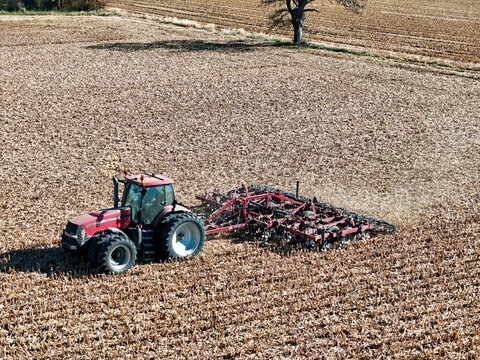 Harvard, Illinois, November 3, 2025 - Case MX285 tractor pulling a Salford I-1200 tiller to  shred corn stalks for the purpose of residue managment