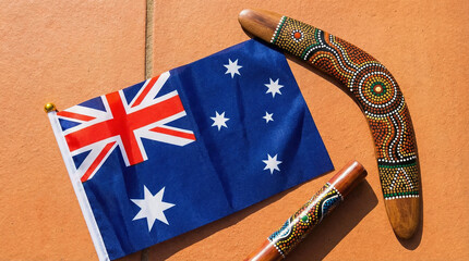 Flag of Australia flatlay with traditional boomerangs and a colorful background